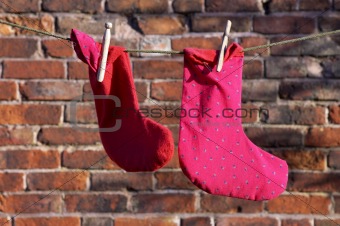 Two socks drying on a washing line