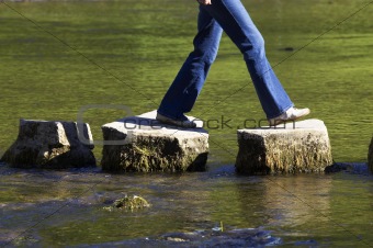 crossing three stepping stones in a river,