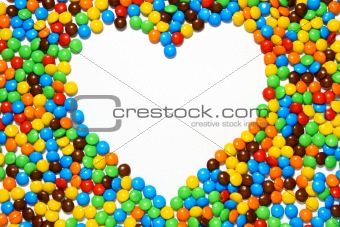White heart shape with candy background