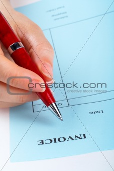 Writing blank invoice with pen