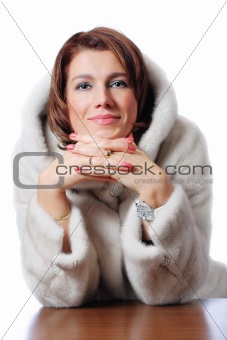 young beautiful women in the fur sitting at the table
