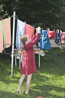 girl hanging clothes to dry
