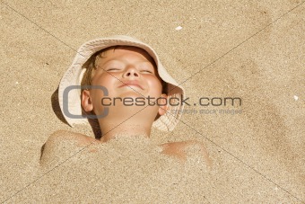 Child buried in the sand