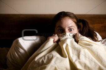 Frightened Woman in Bed