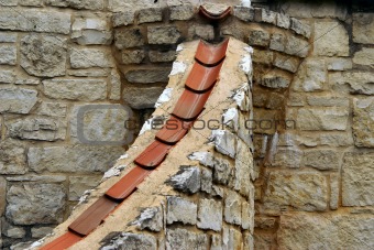 Tile and limestone form a downspout