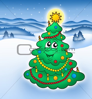 Smiling Christmas tree in snowy landscape