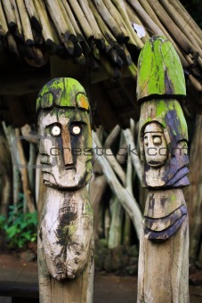 Two wooden totems (idols) near african village