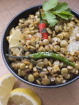 Bowl of Green Lentils cooked with Sliced Lemon Chili and Coriand