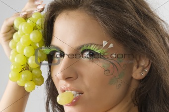 grape between lips
