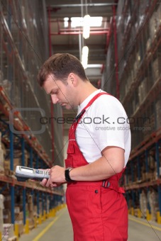 worker with bar code reader in warehouse