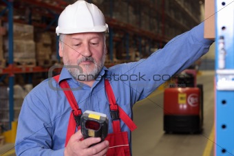 senior worker with bar code reader in warehouse