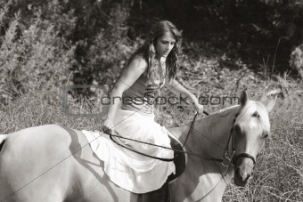 Young woman riding on horse (motion blur)