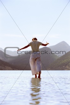 Young woman walking in lake