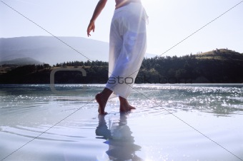 Young woman wading in lake