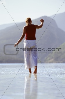 Young woman wading in lake
