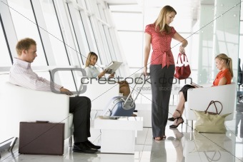 Passengers waiting in airport departure lounge