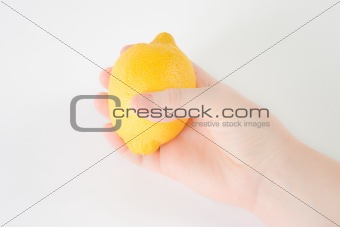 Hand holding a lemon