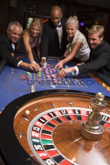 Group of friends gambling in casino