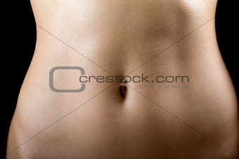 a sexy tummy of the young woman. Isolated on black