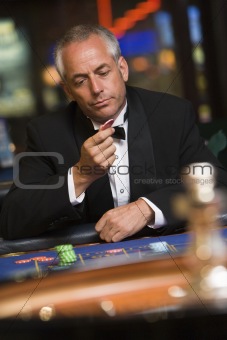 Man losing at roulette table