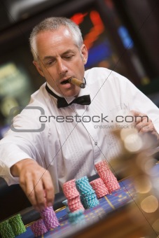 Man placing bet at roulette table