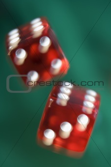 Pair of red dice being thrown