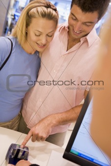 Couple making purchase in store