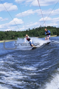 A man and woman water-skiing