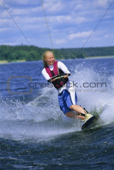 A young woman water skiing