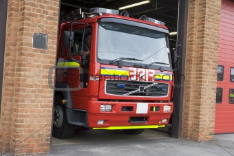 A fire engine leaving the fire station