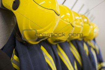 Firefighter's coats and helmets hanging up in a fire station