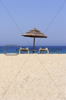 sun lounger on empty sandy beach