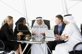 A  business meeting with Middle Eastern and caucasian men and wo