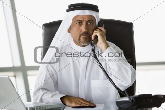 A Middle Eastern businessman talking on the phone