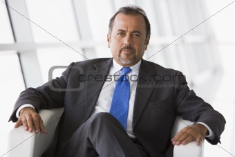 Businessman sitting in chair in lobby