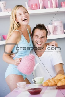 Flirtatious couple enjoying breakfast