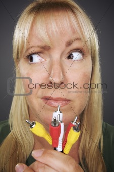 Confused Woman Holding Electronic Cables