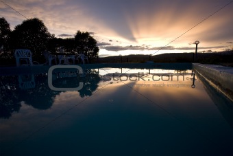 reflection of sunset over swimming pool