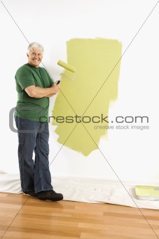 Man painting wall.