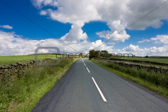 Lane Disappears over a hill, Blue Sky
