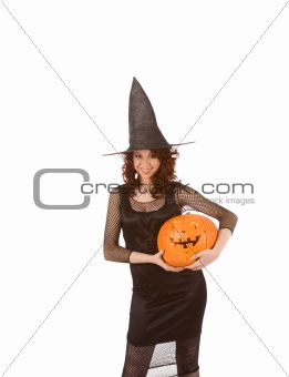 Teenaged girl in Halloween costume with pumpkin(focus on pumpkin