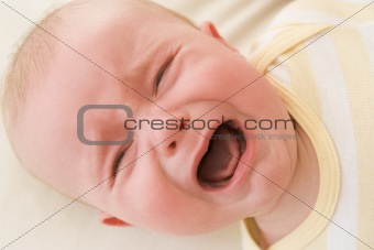 Baby lying indoors crying