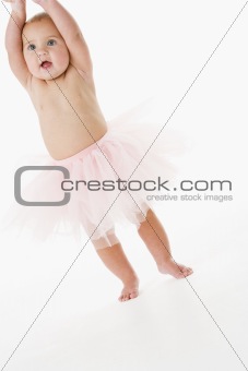 Baby standing in tutu