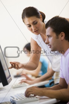 Woman assisting man in computer room