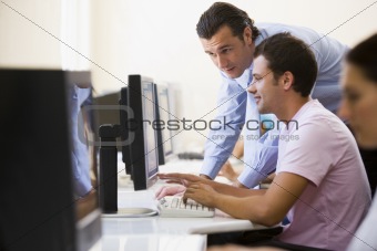 Man assisting other man in computer room