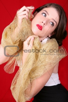 Beautiful Woman Holding Gold Fabric Against Her Face