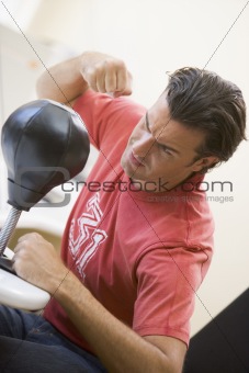 Man indoors using small punching bag