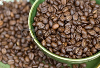 Coffee beans in green cup