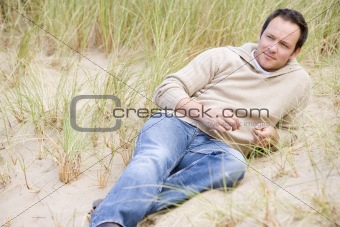 Man sitting back on beach