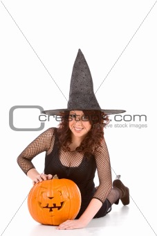 Teen girl in Halloween hat with carved pumpkin  (focus on pumpki